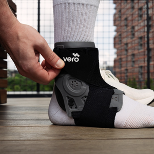 Tightening the upper velcro straps of the Vero Ankle® Brace